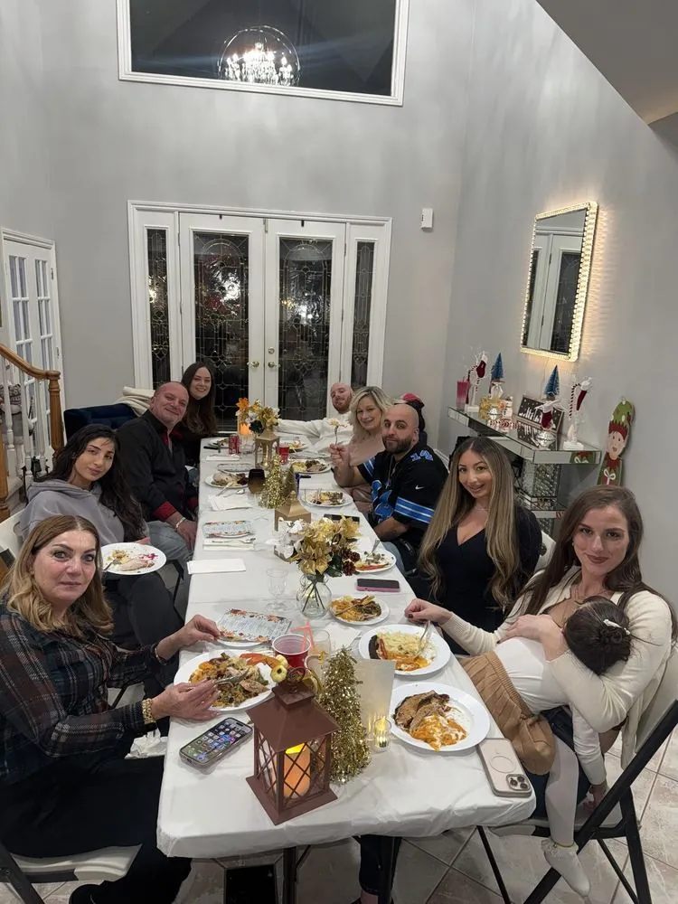 A long table of friends and family gathered together over dinner