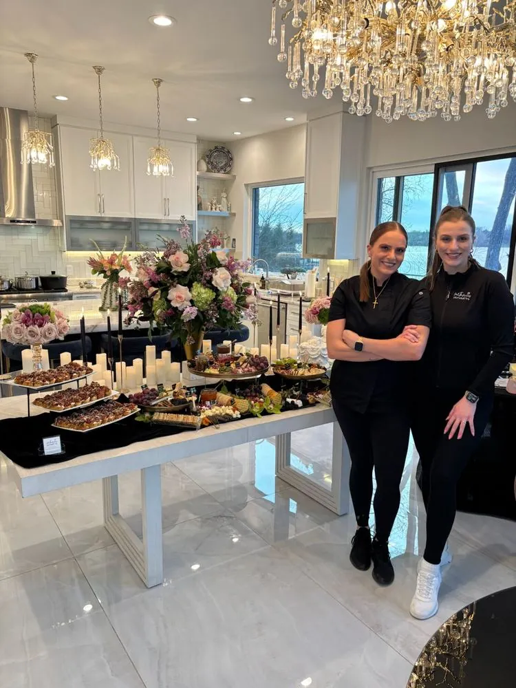 Chef Selena and Mariah together beside a lakeside grazing spread